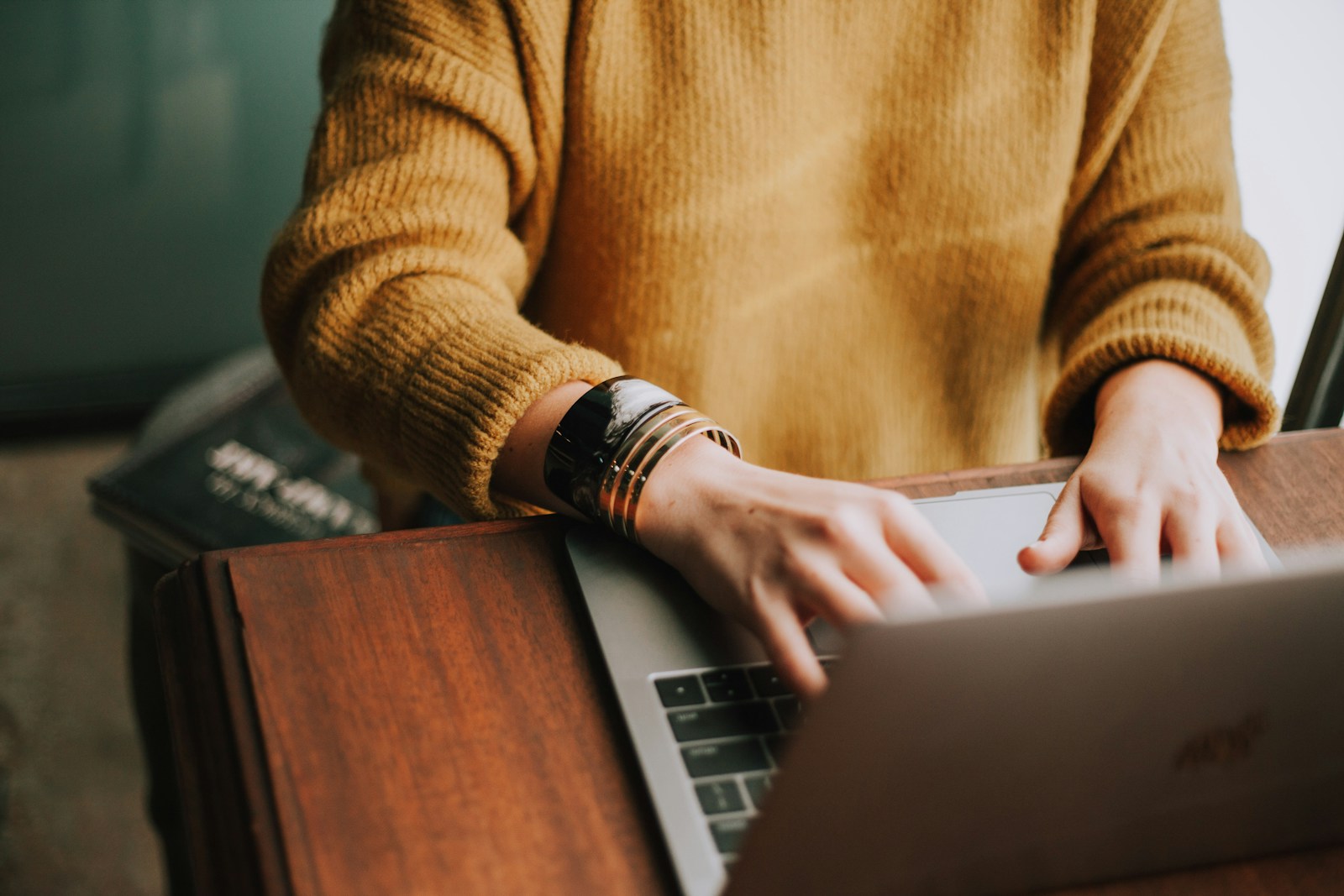 person using laptop computer to write a novel